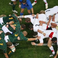 Rugby players packed together in a scrum
