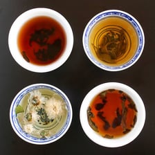 A cup of Chinese tea beside dim sum dishes