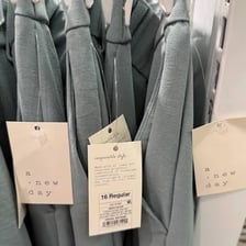 Retail worker replacing a price tag on merchandise
