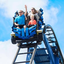 Child showing excitement on an amusement park ride
