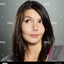 A person with a wry, slightly crooked smile.