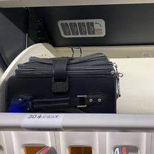 A bag stored securely in an overhead compartment