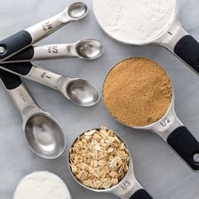 A teaspoon being used to measure a baking ingredient