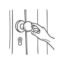 A hand turning a round doorknob.