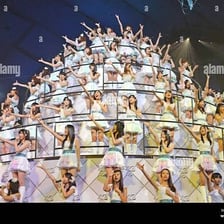 Japanese pop group AKB48 performing at a concert.