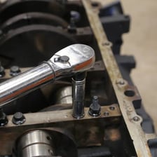 A wrench turning a bolt to demonstrate rotational force