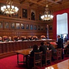 A lawyer presenting a legal argument before a judge.