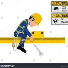 A clumsy worker accidentally dropping tools