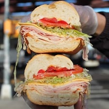 A deli counter displaying sandwiches and prepared foods