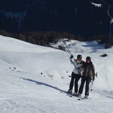 A skier being pulled uphill by a T-bar lift