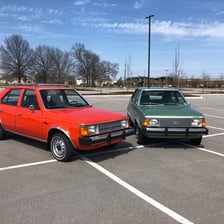 A vintage Dodge Omni compact car.
