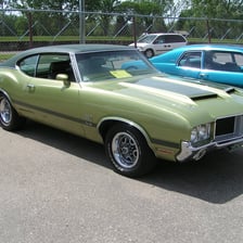 A vintage car made by Oldsmobile