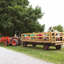 A wagon carrying passengers on a hayride