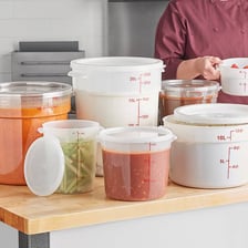 Several plastic food-container lids arranged in a kitchen.