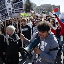 A crowd protesting against an authority figure or government