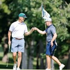 Three golfers playing together on a golf course