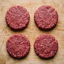 A cooked beef patty in a hamburger.