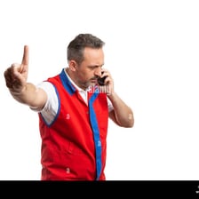 A person signaling someone to wait briefly.