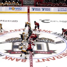 Professional ice hockey players competing in an NHL game.