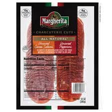 Slices of pepperoni alongside other salami on a serving board