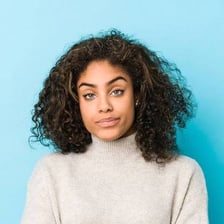 A person wearing a subtle amused smile
