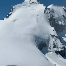 A thick layer of snow forming a snowpack on a mountain slope
