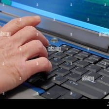 A person entering data on a computer keyboard