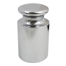A standard one-kilogram mass used for weighing.