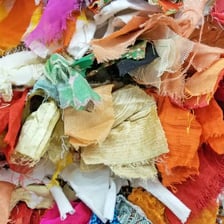 A small, visibly worn piece of cloth lying on a surface