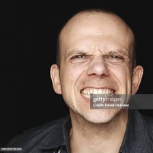 A close-up of a person clenching and grinding their teeth.