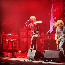 Taking Back Sunday performing live as an emo rock band.