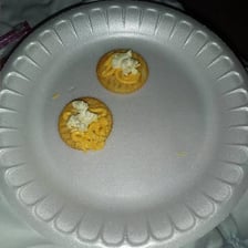 Orange-yellow Cheez Whiz spread on crackers
