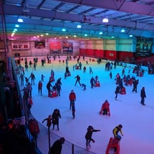 An indoor ice skating rink with a smooth ice surface