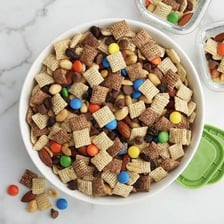 Chex cereal pieces mixed with nuts and other trail-mix ingredients