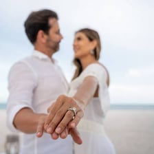 A married couple shown wearing wedding rings
