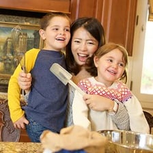 An au pair helping a host family with children at home