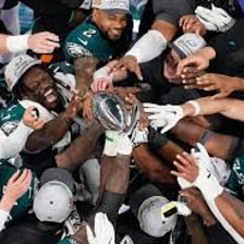 A sports team celebrating after winning by a large margin.