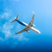 A commercial airplane flying through the sky.