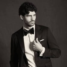 A black tuxedo displayed as formal wedding attire.