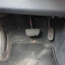 A vehicle interior with visible sand on the seats and floor.