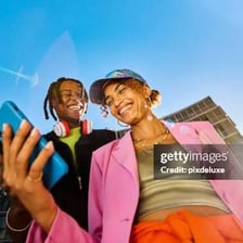 A social media influencer using a phone while seeking online attention