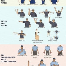 A baseball umpire extending both arms horizontally to signal safe
