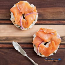 A bagel topped with cream cheese and slices of lox