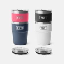 A YETI insulated cooler beside a branded coffee tumbler