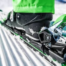A single downhill ski showing its binding