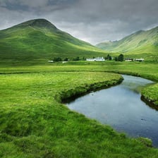 A green low-lying valley between hills