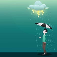 A person using an umbrella during rainfall