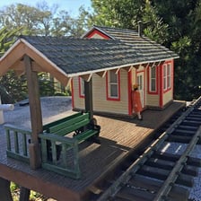 A train stopped at a small railroad station