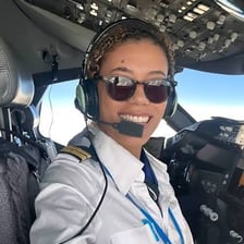 An airline pilot seated in an aircraft cockpit