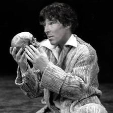 A theatrical depiction of Hamlet delivering the “To be or not to be” soliloquy